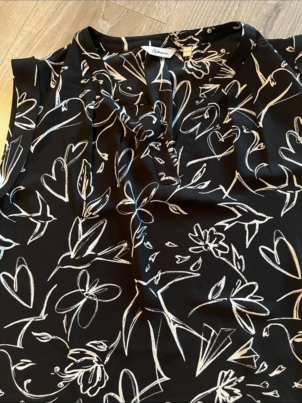 Reitmans Black Sleeveless Camisole with White pattern. Pleated split neck.
